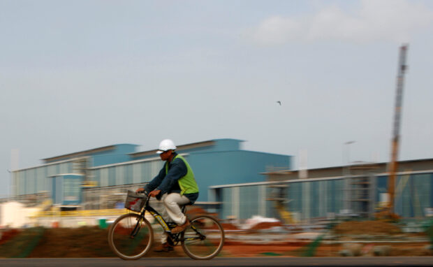 A worker rides his bicycle