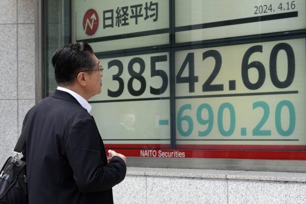 Asian shares track Wall St slump triggered by strong US spending data