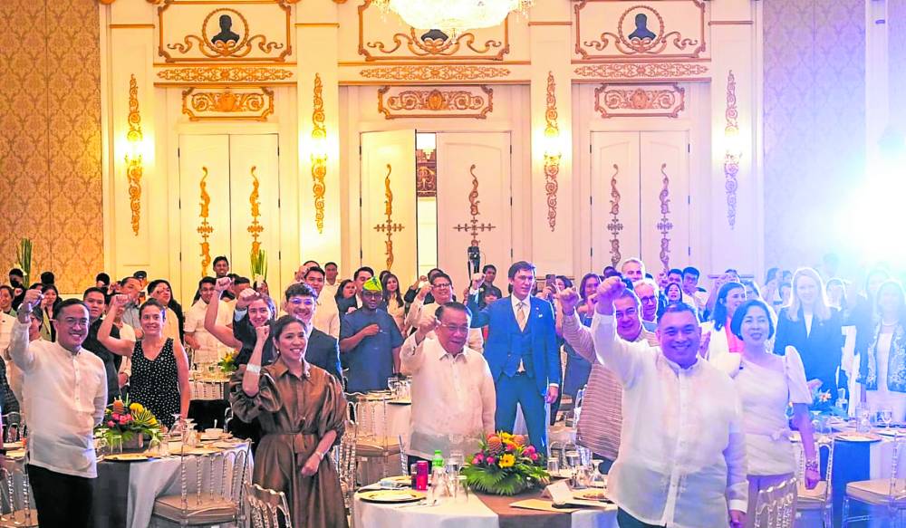  Open Government Partnership (OGP) chair and Budget Secretary AmenahPangandaman (in gold, third from left), Executive Secretary Lucas Bersamin, Foreign Undersecretary Jesus Domingo (right), and OGP cochair for civil society Aurora Chavez, with members of the Diplomatic Corps, cheer “OGPinas!” 