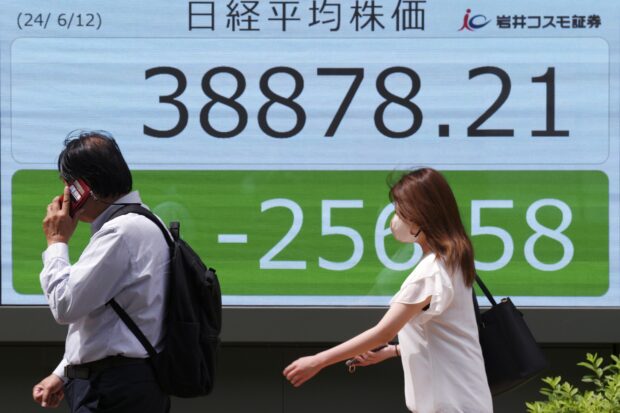 Asian shares mostly lower ahead of Fed decision on interest rates