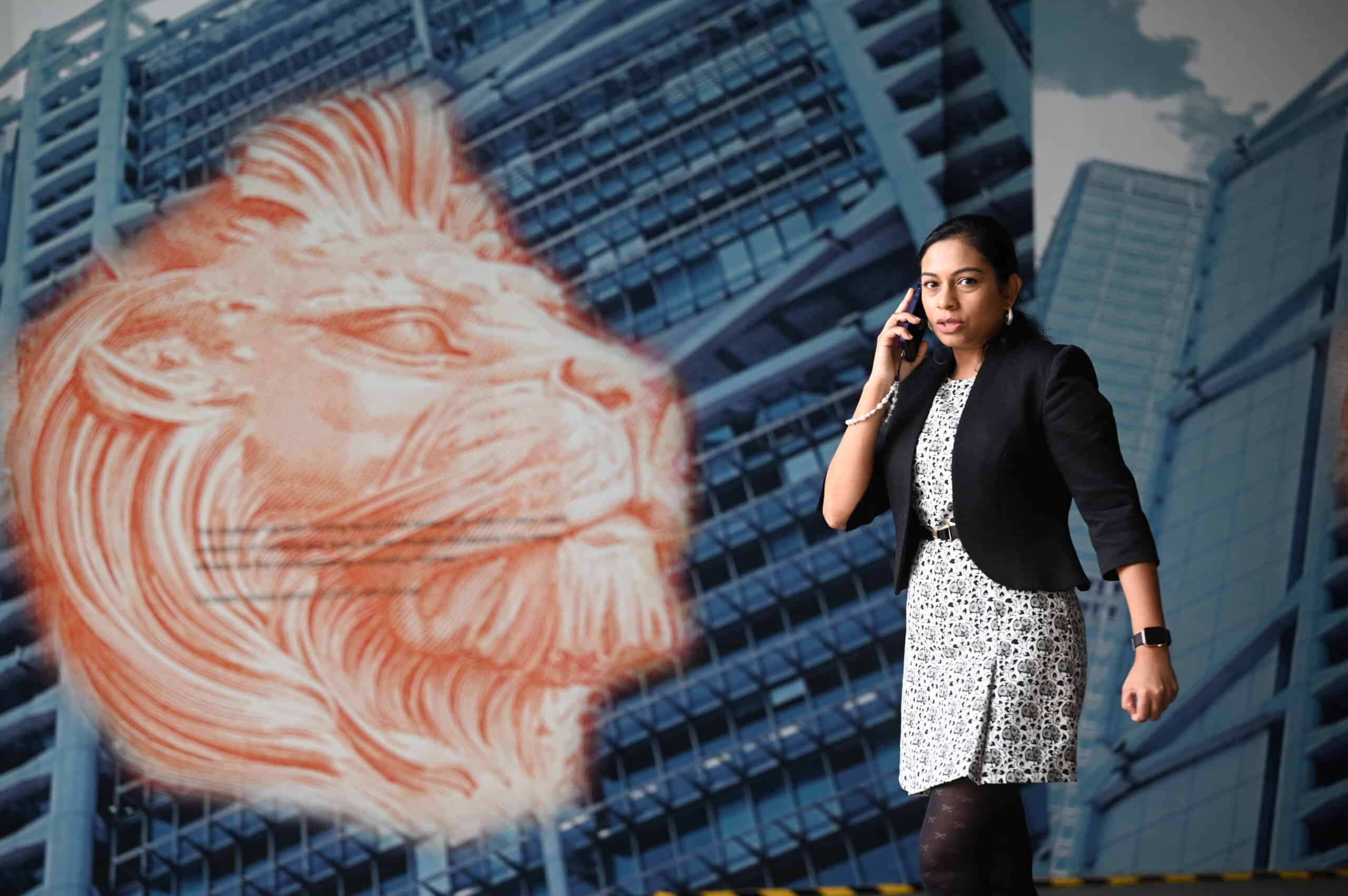 A woman walks outside the headquarters of the Hong Kong and Shanghai Banking Corporation Limited (HSBC) in Hong Kong on February 21, 2024.