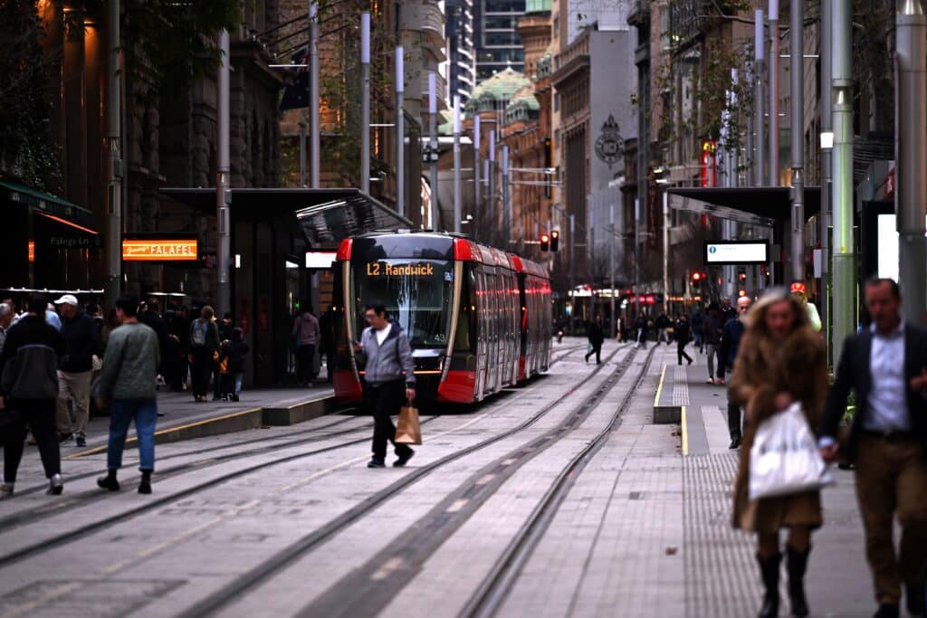 A light rail makes its way through George Street in the central business district of Sydney on July 19, 2024. A large-scale outage wrought havoc on IT systems across Australia, with the country's national broadcaster, its largest international airport, and a major telecommunications company reporting issues. (Photo by Saeed KHAN / AFP)