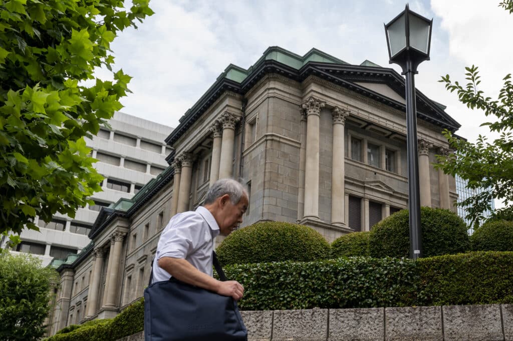 A man walks past the Bank of Japan (BoJ) headquarters in Tokyo on July 31, 2024. 