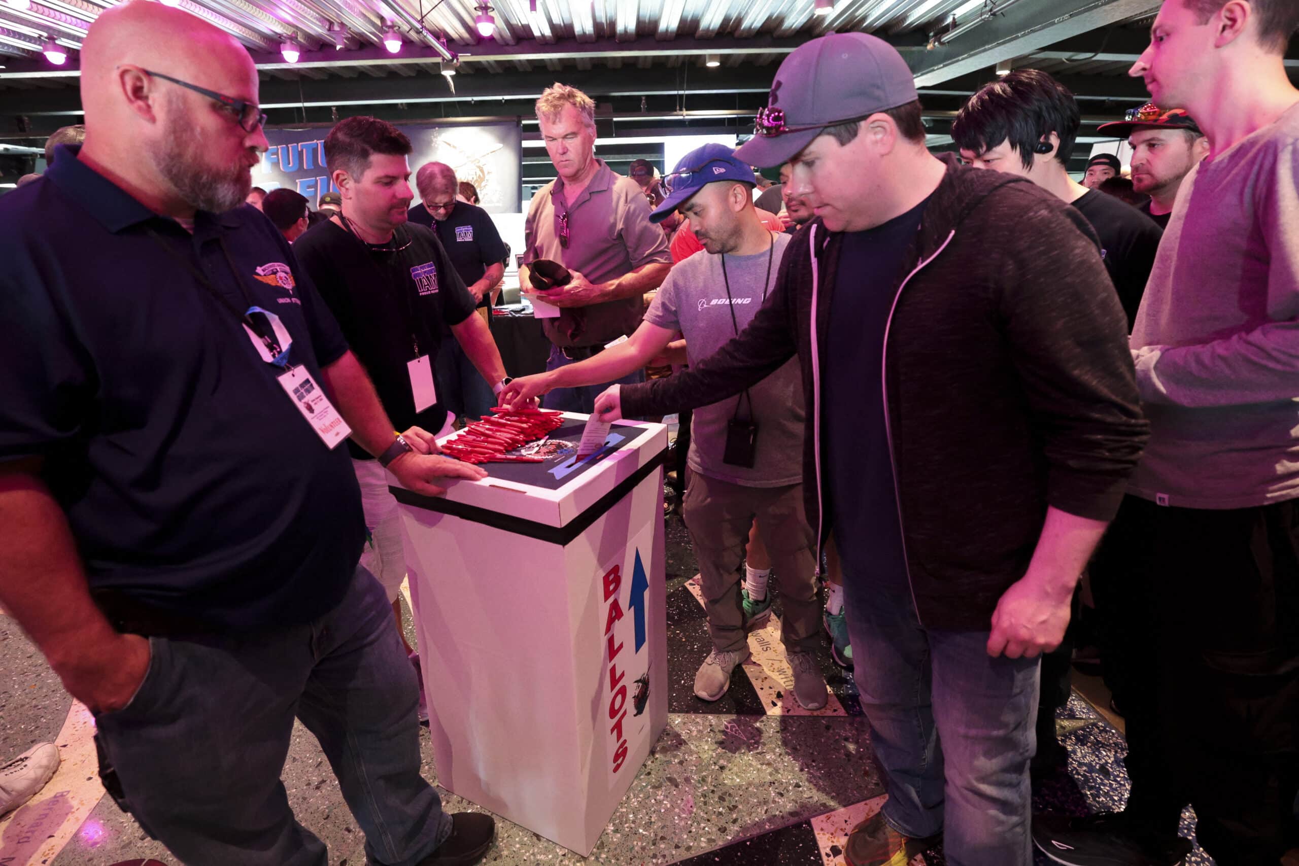 International Association of Machinists and Aerospace Worker Union (IAM) District 751 members drop their ballots into a ballot box during an early strike-sanction vote event at T-Mobile Park in Seattle, Washington on July 17, 2024.