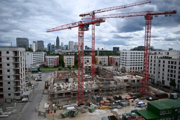 Cranes stand on a construction site for housing appartments in Frankfurt am Main, western Germany, on May 28, 2024.