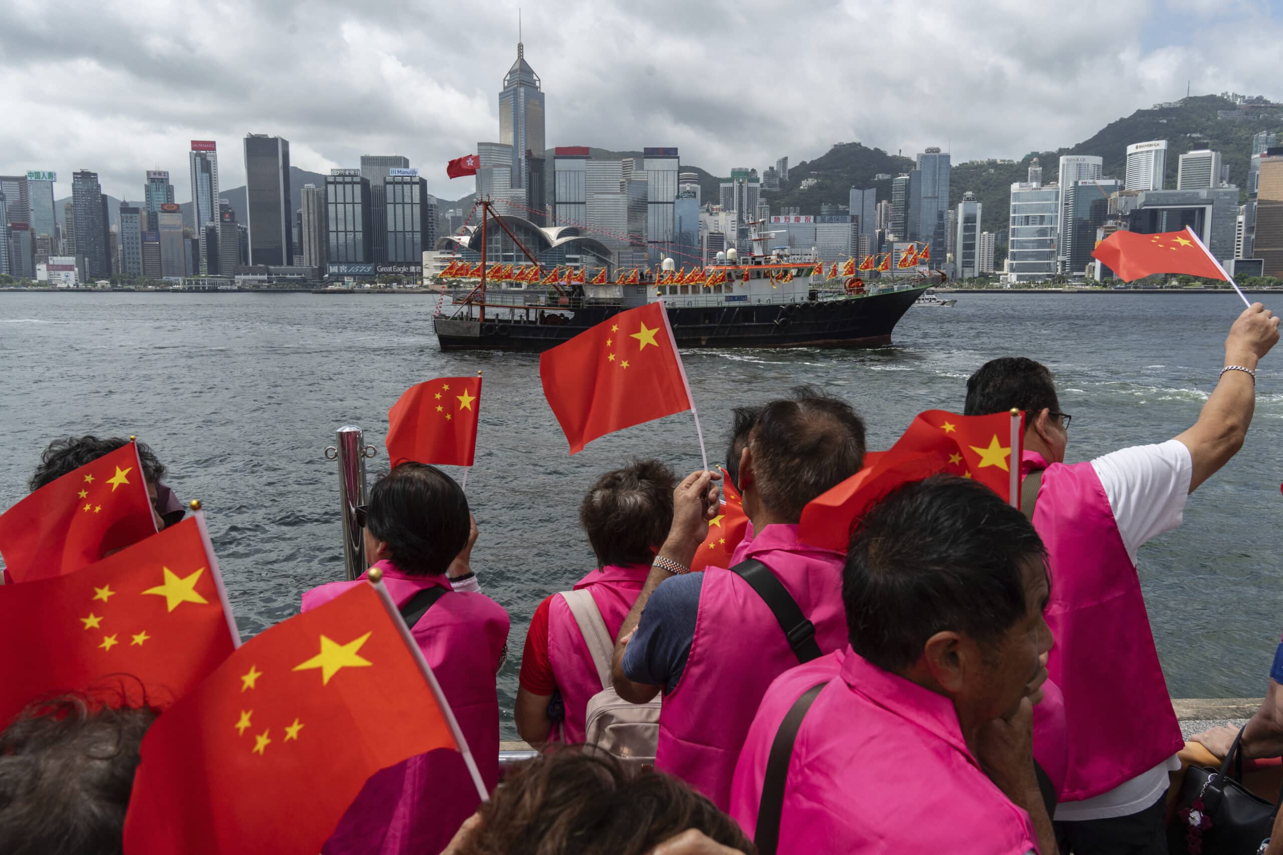 Pro-Beijing supporters hold Chinese flags to mark the 27th anniversary of Hong Kong's return to Chinese rule in Hong Kong, Monday, July 1, 2024. 