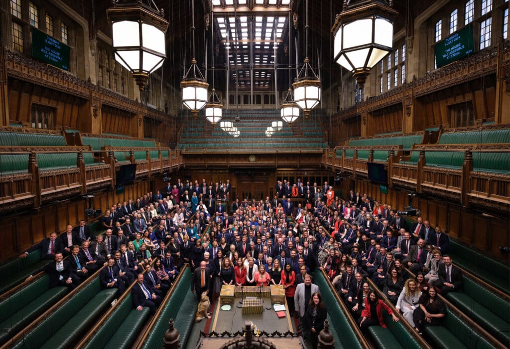 A handout photograph released by the UK Parliament shows the new MPs posing for a photograph as they meet for the first time since Britain's general election at the House of Commons in London on July 9, 2024.