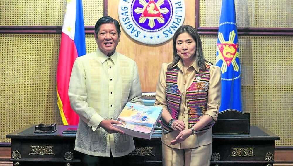 FISCAL MANAGEMENT President Marcos receives a copy of the New Expenditure Policy 2025 from Budget Secretary Amenah Pangandaman at the Malacañang Palace on July 31.