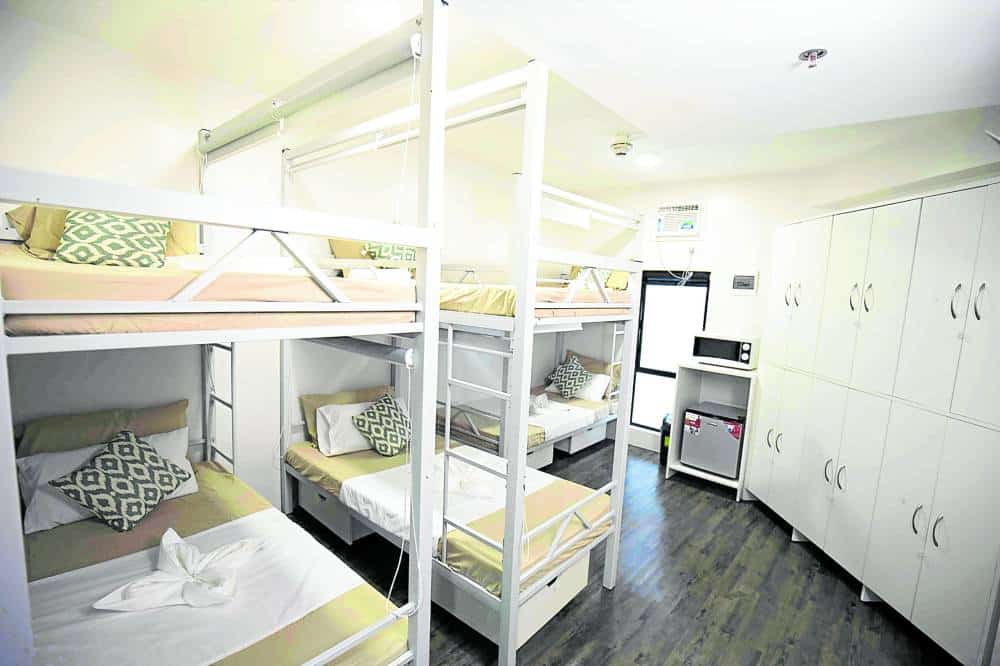 ROOMIES A six-bed unit with living essentials, including a refrigerator and microwave oven.