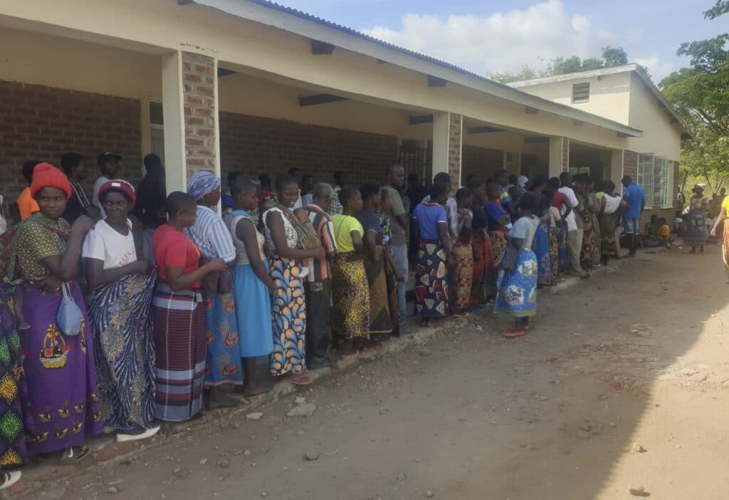 People queue for food at a World Food Programme distribution center in Neno district southern Malawi, March 24, 2024.