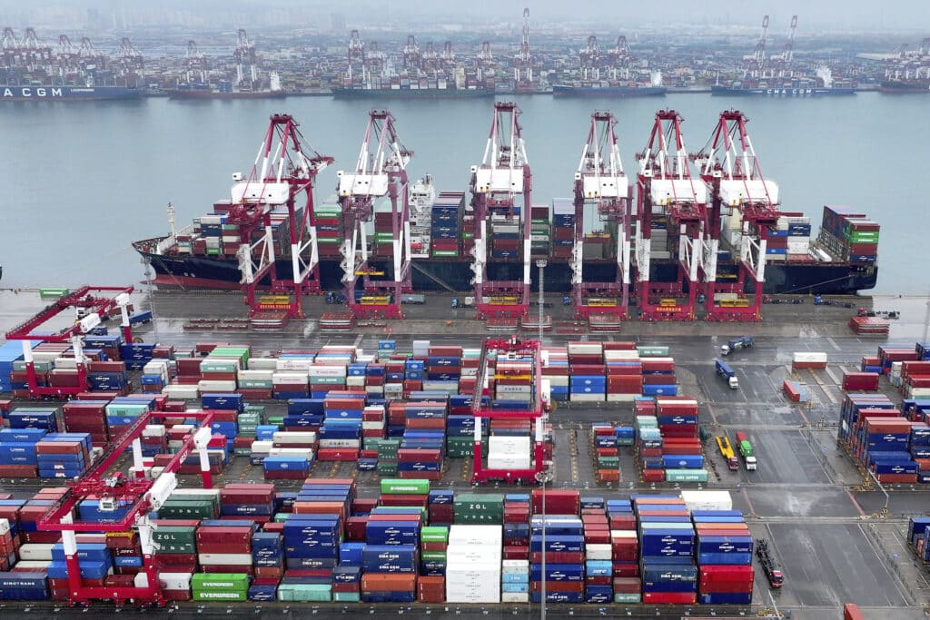 Cranes and transporters work at an automated container port in Qingdao in eastern China's Shandong province, on July 7, 2024.