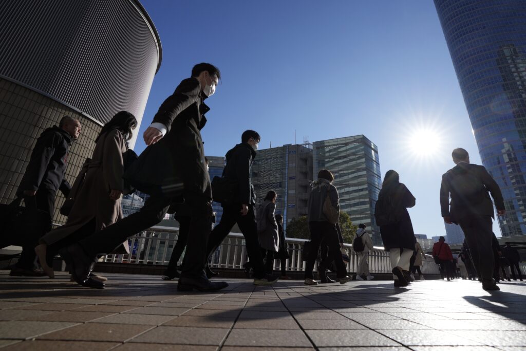 Commuters walk in a passageway during a rush hour at Shinagawa Station Wednesday, Feb. 14, 2024, in Tokyo. 