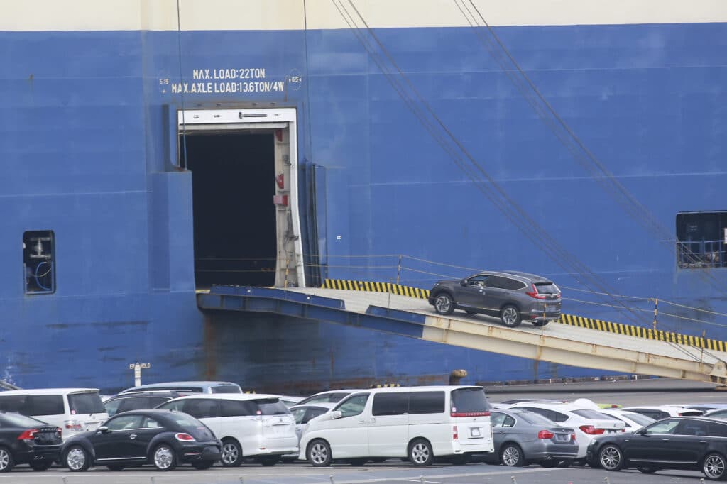 Cars for export are loaded onto a cargo ship at a port in Yokohama, near Tokyo on Nov. 2, 2021. 