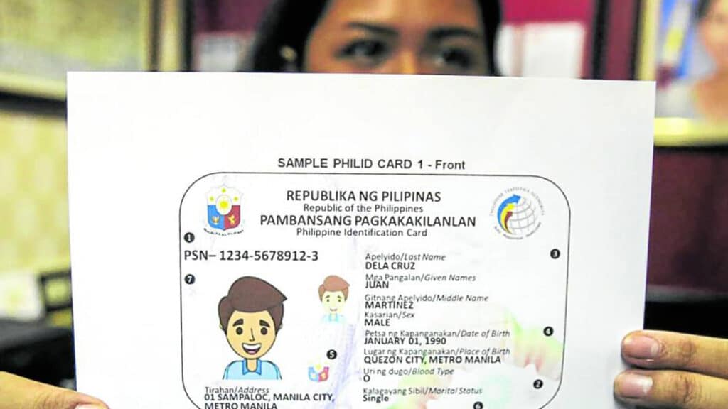 FILE PHOTO: A congressional worker shows a sample of the PhilSys ID presented to the House of Representatives when the Philippine Statistics Authority was seeking funding in October 2022. INQUIRER FILES