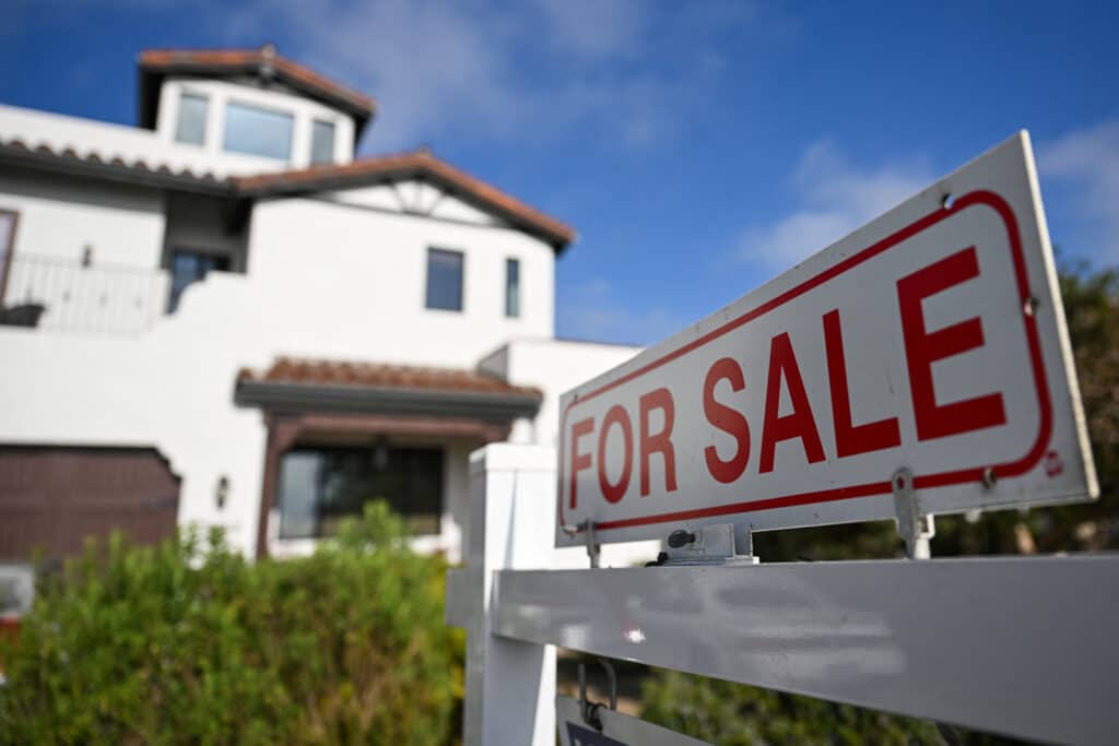 (FILES) A for sale sign is displayed outside of a home for sale on August 16, 2024 in Los Angeles, California. 