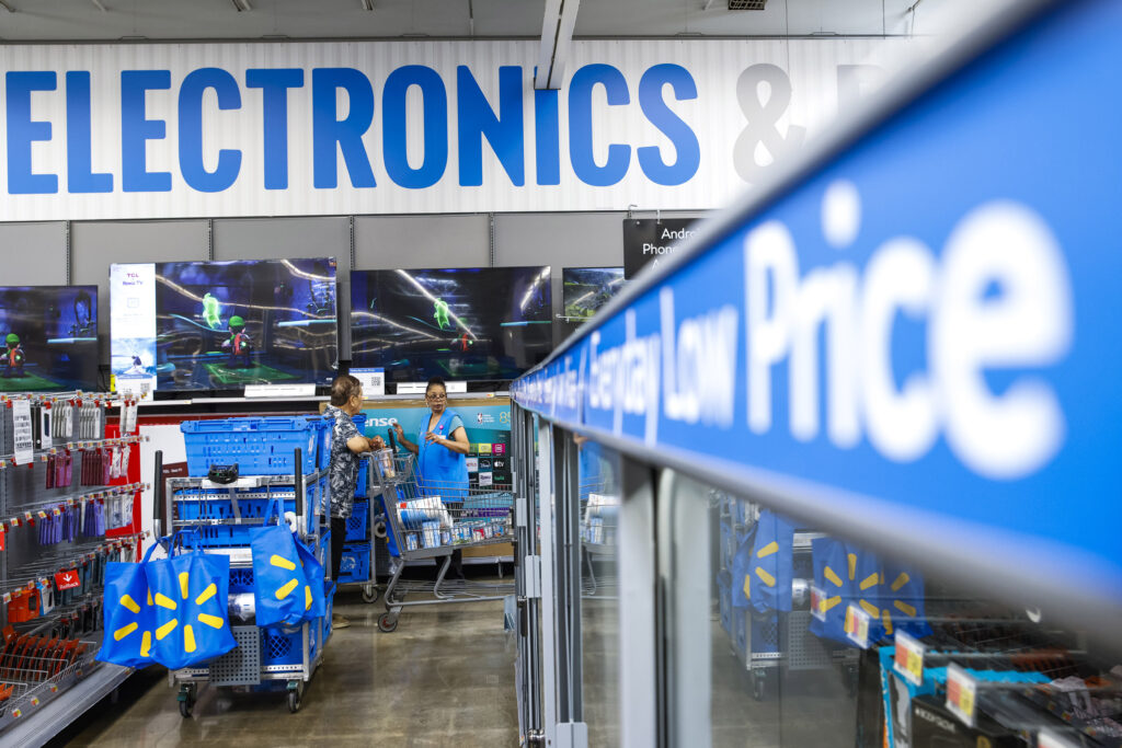 People walk around a Walmart Superstore in Secaucus, New Jersey, on July 11, 2024. 