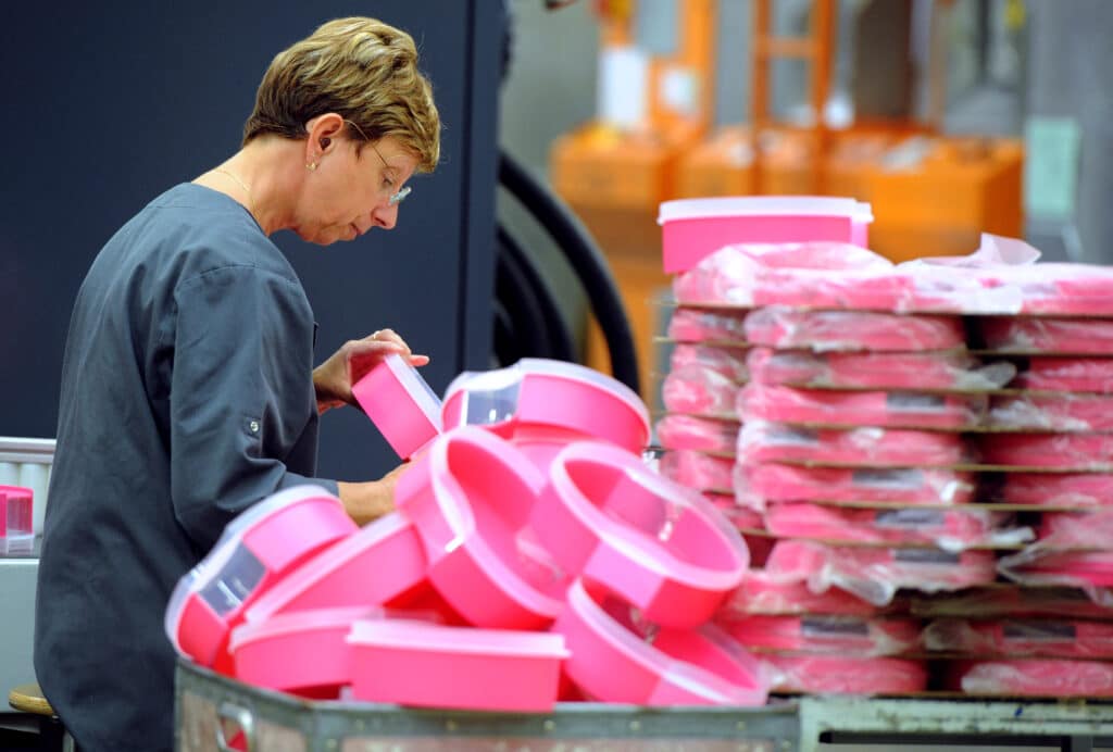 An employee of Tupperware Brands Corporation is at work on the production line, on August 27, 2013 at the group's plant in Joue-les-Tours, centre France, on the day of its 40th anniversary. 