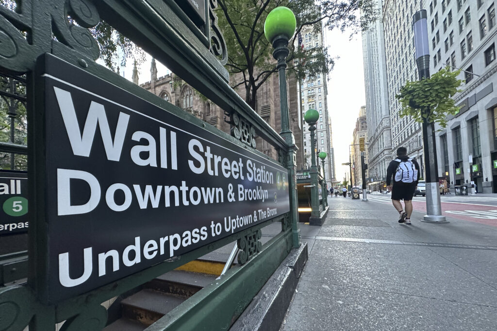 People pass the entrance for the Wall Street subway station on Tuesday, Sept. 2, 2024, in New York.