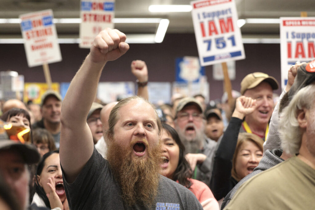 (FILES) Ryan Bergh, a machinist at Boeing's factory in Everett, Washington for 10 years, cheers during a strike rally for the International Association of Machinists and Aerospace Workers (IAM) at the Seattle Union Hall in Seattle, Washington, on October 15, 2024.