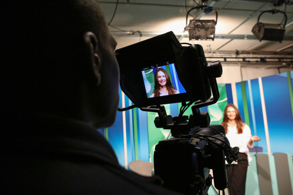 Czech Republic student, 19-year-old Denisa Lacinova is pictured through the monitor of a camera in the media room at the South East Technological University (SETU) in Carlow, eastern Ireland on September 24, 2024.