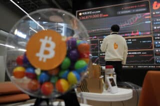 Most Asian markets track Wall St gains, bitcoin closes on $100,000