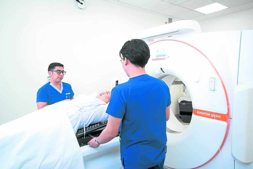 Two hospital workers attending to a patient