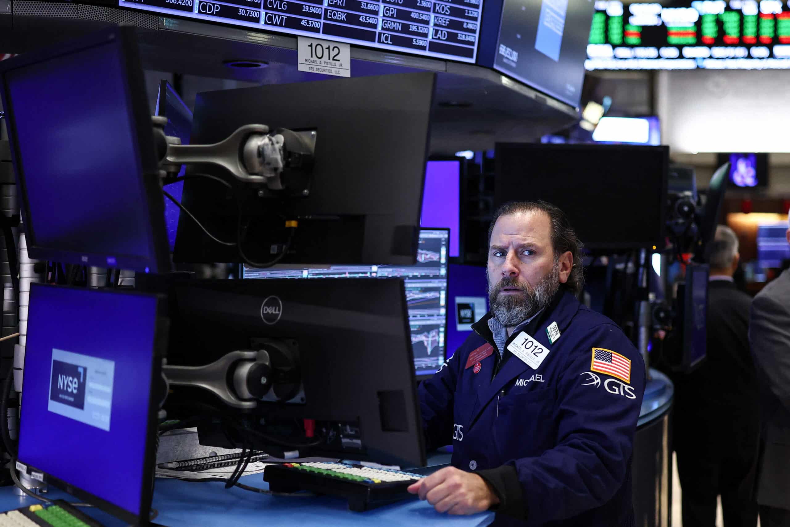 Stocks turn lower as traders eye US data for Fed signals