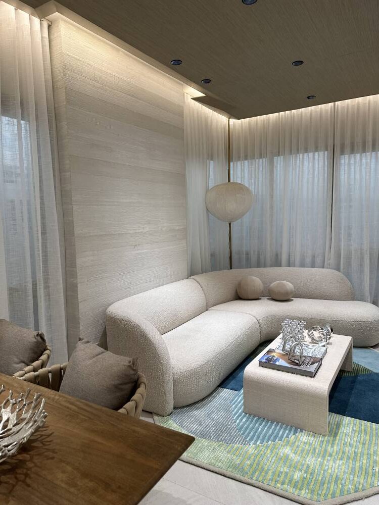 Full curtains in a monochromatic color scheme with a strike of color on the rug